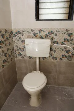 A commode in a bathroom Stock Photos