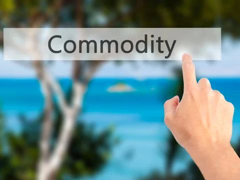 Commodity - Hand pressing a button on blurred background concept on visual sc Stock Photos