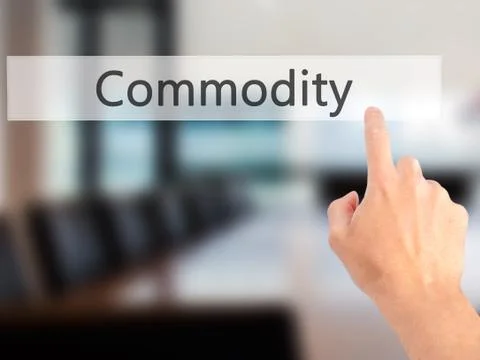Commodity - Hand pressing a button on blurred background concept on visual sc Stock Photos