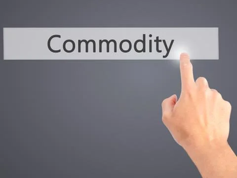 Commodity - Hand pressing a button on blurred background concept on visual sc Stock Photos