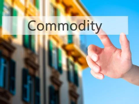 Commodity - Hand pressing a button on blurred background concept on visual sc Stock Photos