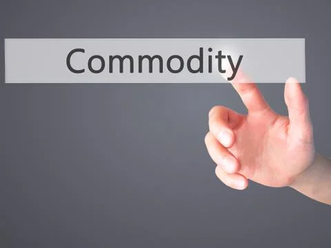 Commodity - Hand pressing a button on blurred background concept on visual sc Stock Photos