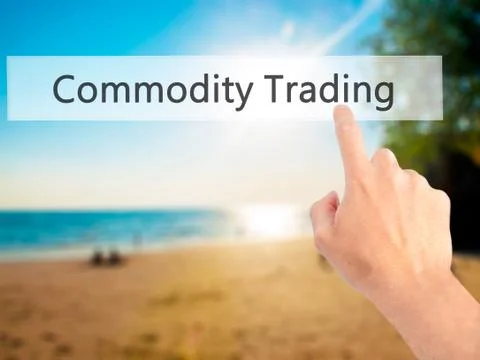 Commodity Trading - Hand pressing a button on blurred background concept . Bu Stock Photos