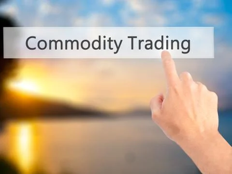Commodity Trading - Hand pressing a button on blurred background concept . Bu Stock Photos