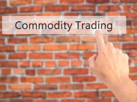 Commodity Trading - Hand pressing a button on blurred background concept . Bu Stock Photos