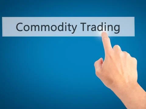 Commodity Trading - Hand pressing a button on blurred background concept . Bu Stock Photos