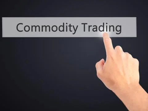 Commodity Trading - Hand pressing a button on blurred background concept . Bu Stock Photos