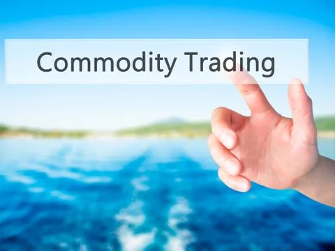Commodity Trading - Hand pressing a button on blurred background concept . Bu Stock Photos