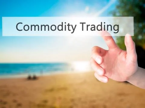 Commodity Trading - Hand pressing a button on blurred background concept . Bu Stock Photos