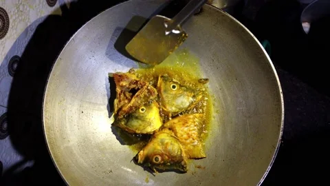Common carp fish head and tail being fried in aluminium kadai Stock Footage 206468810