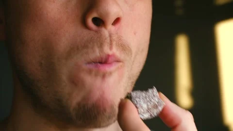 Common person experiences joy while tasting sugary sweets within laidback Stock Footage 337547270