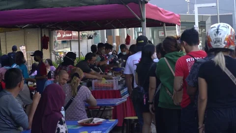 A common sight, long queue on a Sunday morning of customers buying Stock Footage 219404232