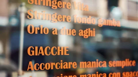 Common tailor services list on atelier store window in Italian language with Stock Footage 250019831