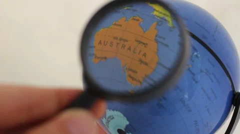 Commonwealth of Australia - World Globe Element through a magnifying glass Stockbeeldmateriaal 67243171