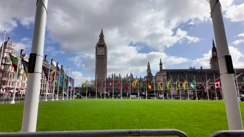 Commonwealth unity and global relations Flags of nations surround Parliament Vídeo Stock 332257004