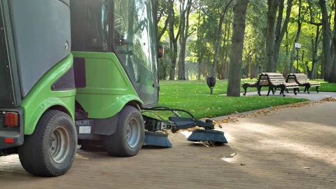 Communal services clean the cobblestones using a small sweeper Stock Footage 217377938