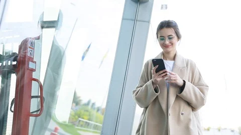 Communicates via smartphone (phablet). Steady cam shot, slow motion.autumn look Stock Footage 122014159