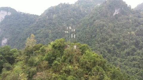 Communication base stations and antennas on a mountain top in karst terrain Видео 234181109