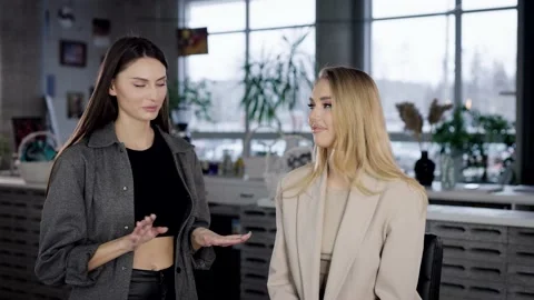 Communication between two female friends in a beauty salon, Blonde and brunette Stock Footage 236400062