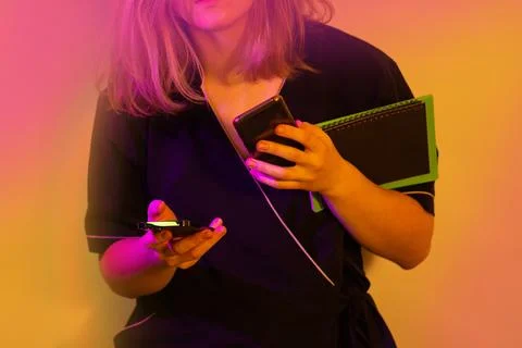 Communication with the client using two phones at the same time. Young woman  스톡 사진