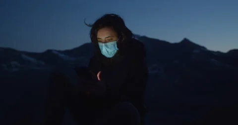 Communication concept, the manager in the mask sits on top of the car and uses Stock Footage 139899239