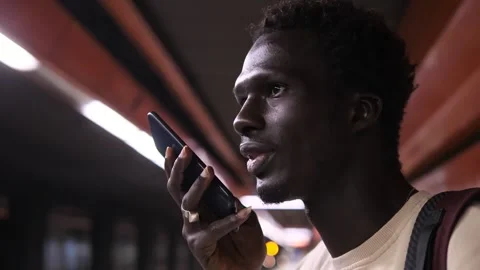 Communication, connection - black man at the metro station talks on phone  Stock Footage 240325730