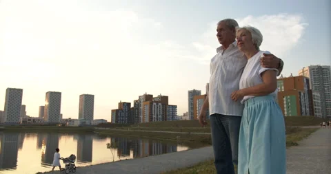 Communication of an elderly couple against the background of a city pond Stock Footage 135579830