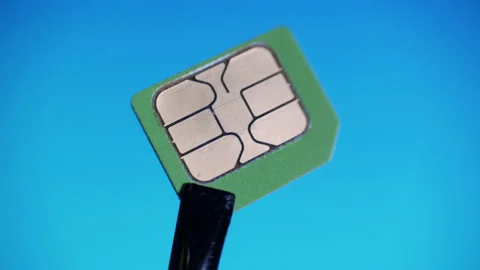 Communication equipment engineer in gloves holding tweezers green micro SIM card Stock Footage 130814137