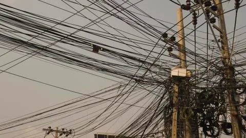 Communication lines that look cluttered on electrical poles, Look disorganized. Stock Photos