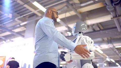 Communication robot and human. a man hugs a woman robot. Modern Robotic Stock Footage 86451488