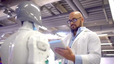 Communication robot and human. a man hugs a woman robot. Modern Robotic Stock Footage 86451605