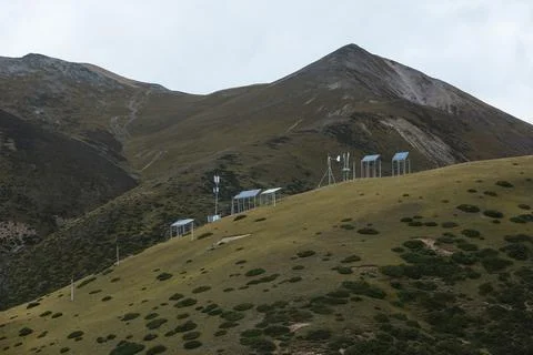 Communication signal equipment powered by solar energy on a hillside full of  Stock Photos