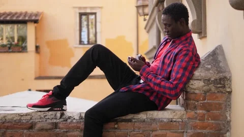 Communication, technology concept: Black man writing a message on his smartphone Stock Footage 219623985