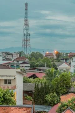 Communication tower above rooftops Stock Photos