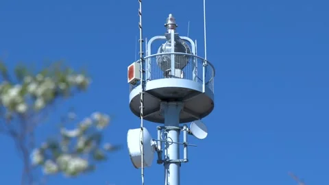 Communication Tower and Satellite Dishes Against a Clear Blue Sky Vídeos de archivo 327688828