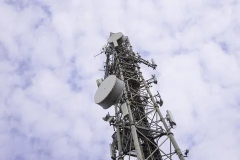Communication tower on a blue sky with clouds 스톡 사진