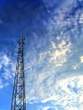 Communication Tower in Cloudy Sky Stock Photos