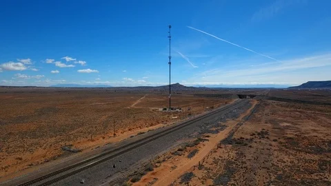 Communication tower in the desert with a blue sky background. 스톡 동영상 126584426