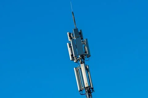 Communication tower reaching towards the clear blue sky Stock Photos