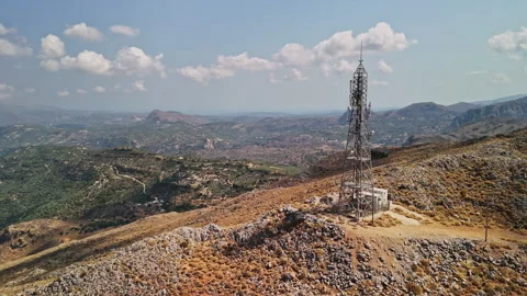 Communication tower stands on a mountain overlooking a vast landscape Stock Footage 287041241