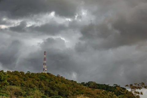 Communication tower at top of mountain with clouds Foto stock