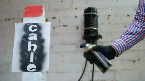 Communication worker draws on the warning cable post Stock Footage 150166754