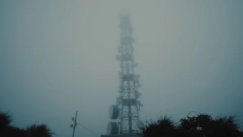 Communication,broadcast and cell tower on mountain top extreme weather, mist fog Stock Footage 73412284