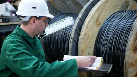 A communications engineer works with an optical fiber cable. Stock Footage 128933078