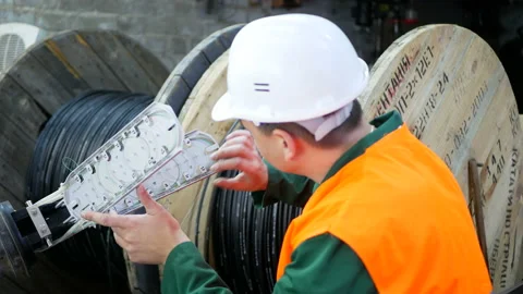 A communications engineer works with an optical fiber cable. Stock Footage 151416959
