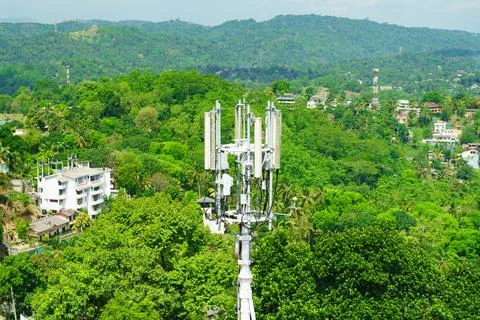 Communications tower against the backdrop of a mountain village Stock Photos