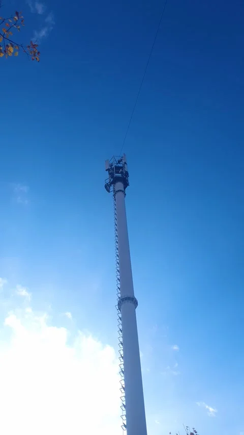 Communications Tower vertical. A metal tower used by a cellular carrier Stock Footage 348108702