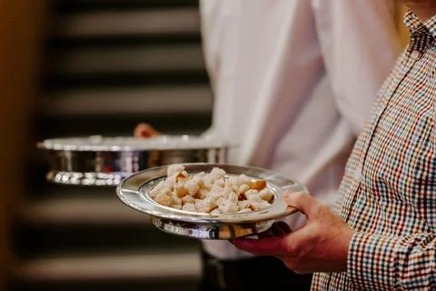 Communion with bread and wine during the service in the assembly Stock Photos
