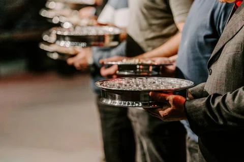 Communion with bread and wine during the service in the assembly Stock Photos