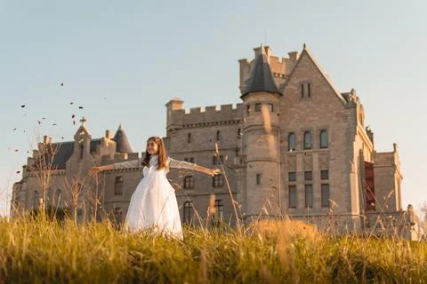Communion girl playing in front of a beautiful castle Stock Photos